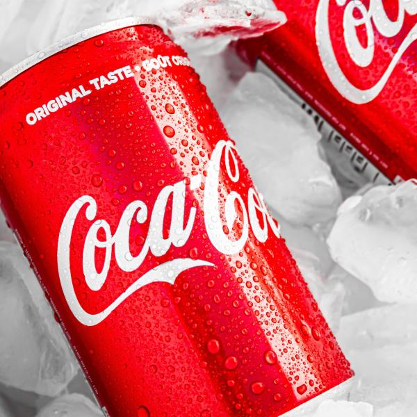 Two cans on Coca Cola in ice